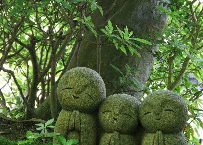 Peaceful stone statues illustrating the calm perspective on the biological process of dying.